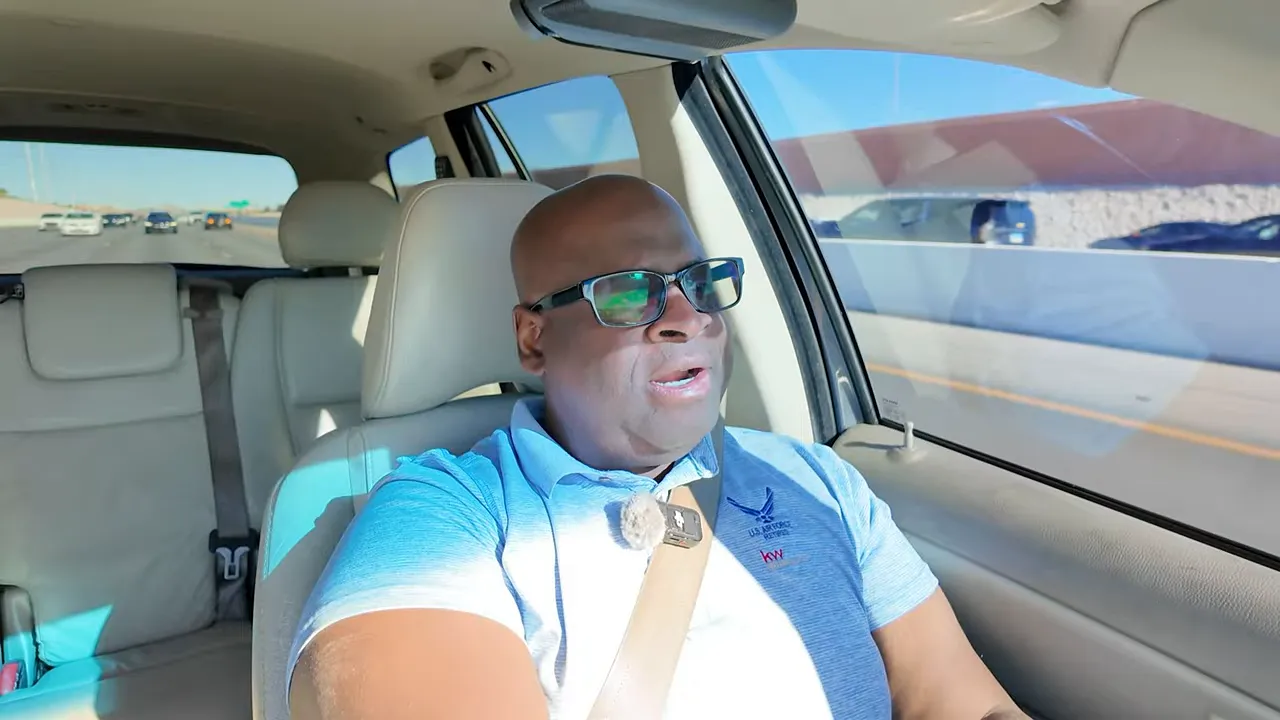 Host speaking to camera inside a car, clear view of interior and road — discussing buyer-broker representation agreements and paperwork.