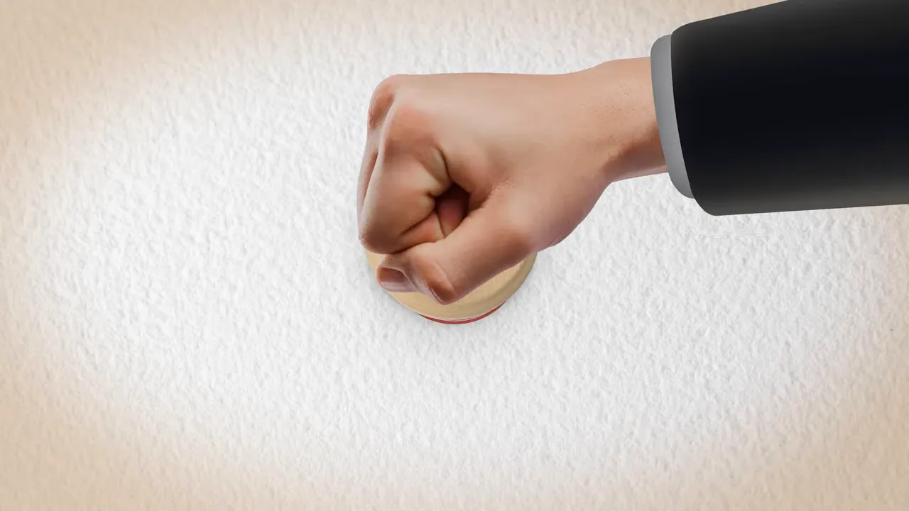 Close-up of a hand pressing a round ceiling alarm or button, illustrating an unexpected home emergency