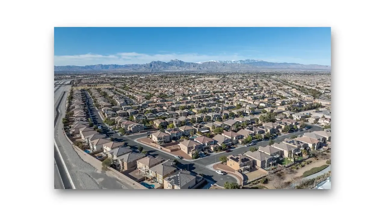 wide drone view of suburban homes in Las Vegas with highway access visible at the edge
