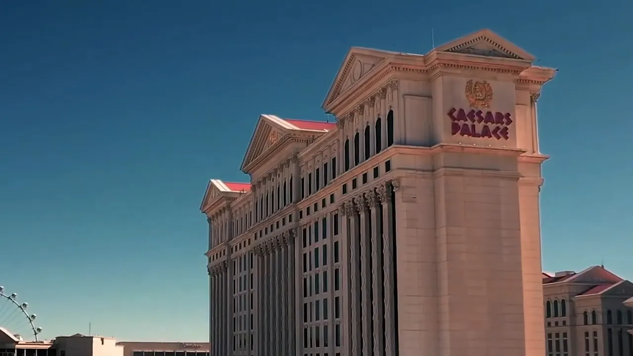 Exterior of Caesars Palace hotel-casino in Las Vegas with clear blue sky and visible signage.