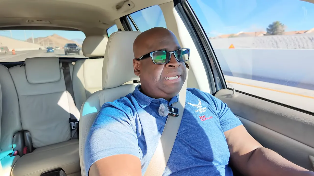 Real estate host in car reviewing pricing strategy while passing homes and road barriers