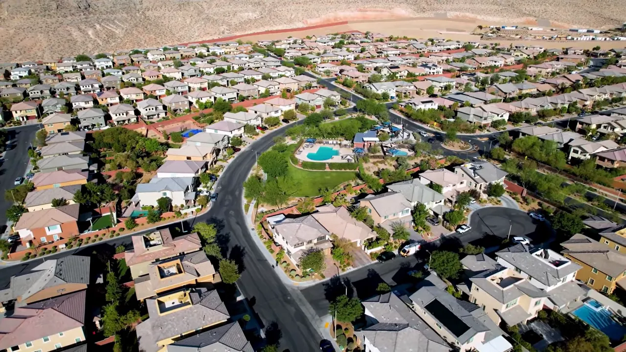Aerial view of a master-planned residential community near Nellis Air Force Base with homes and pools
