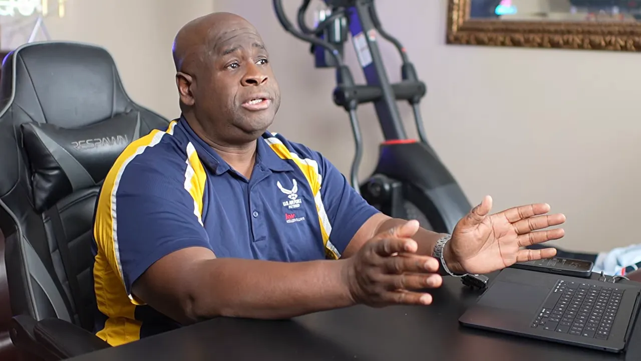 Military housing planning video still: presenter at a desk explaining VA loan advantages for Las Vegas PCS families