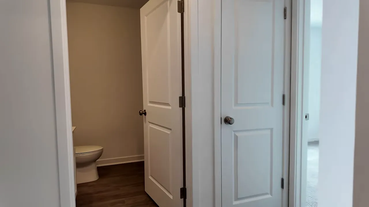 Mesa plan hallway doors with closet and bathroom entry in a new single-story home