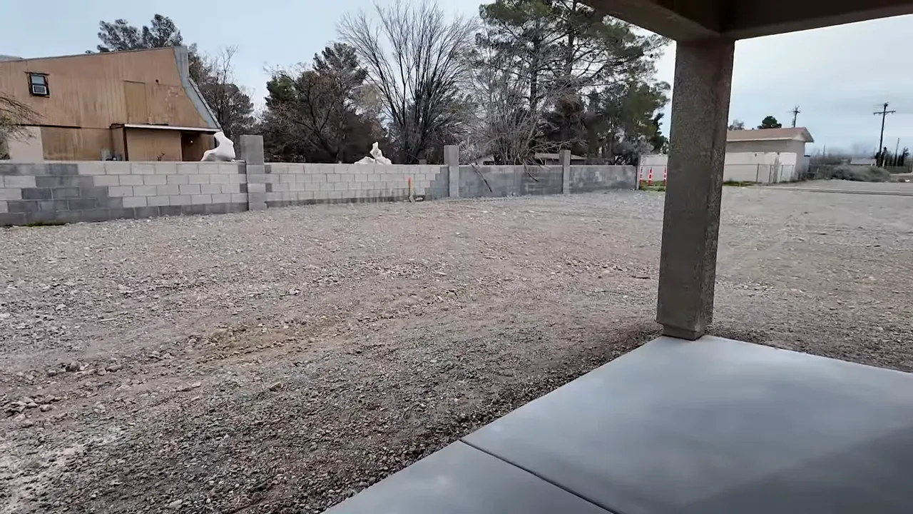 View from a covered patio looking over a large, undeveloped backyard lot in Pahrump Nevada