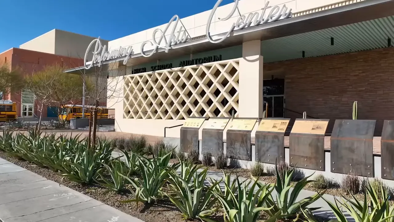 Exterior entrance signage and facade of a downtown performing arts center with landscaping