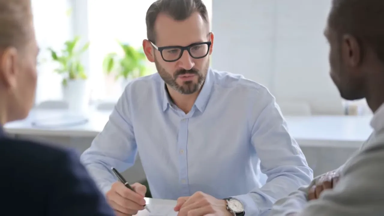 real estate agent discussing a buyer broker representation agreement and commission terms with clients