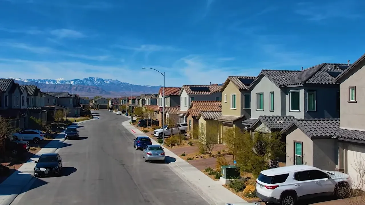 Residential street view in a Las Vegas neighborhood with houses and parked cars