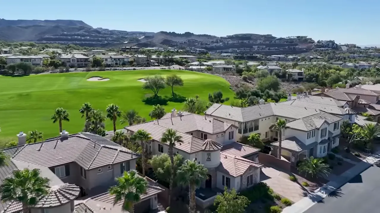 Aerial view of Las Vegas neighborhood with golf course and homes