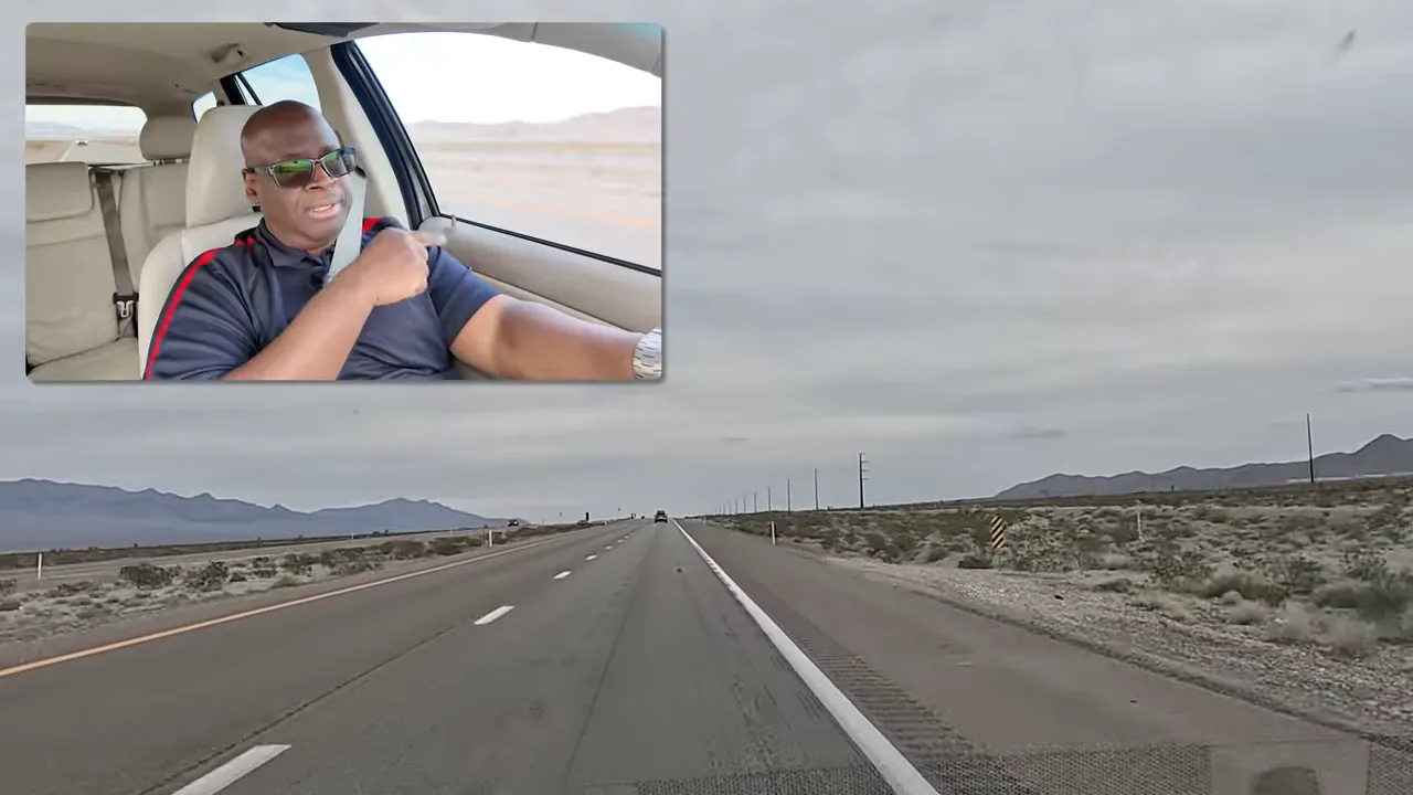 Long straight highway with desert landscape during the commute to Creech Air Force Base