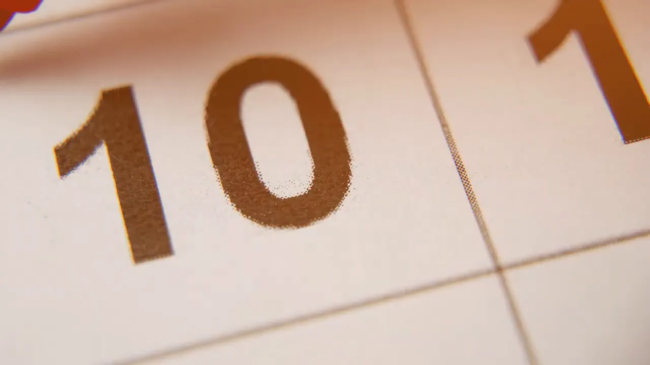 Close-up of a calendar showing the number 10 to represent deadlines and timing.