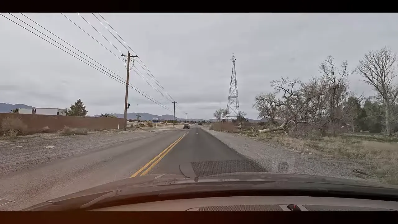Two-lane road in Pahrump Nevada with utility lines and open landscape