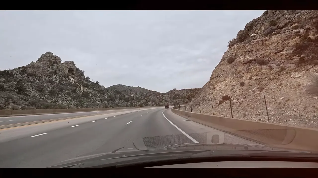 Curving highway through rocky terrain on the drive to Pahrump, Nevada