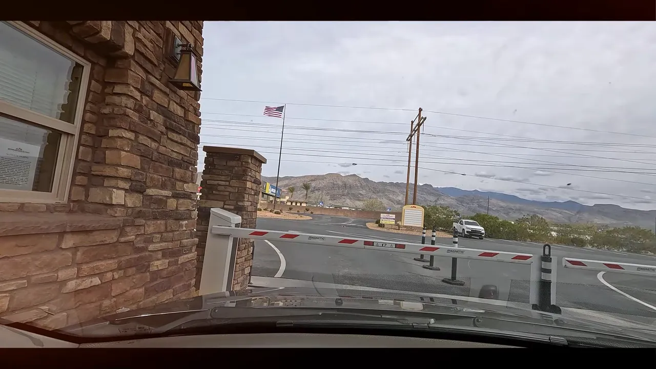 Vehicle approaching a gated area with desert mountains outside Pahrump Nevada