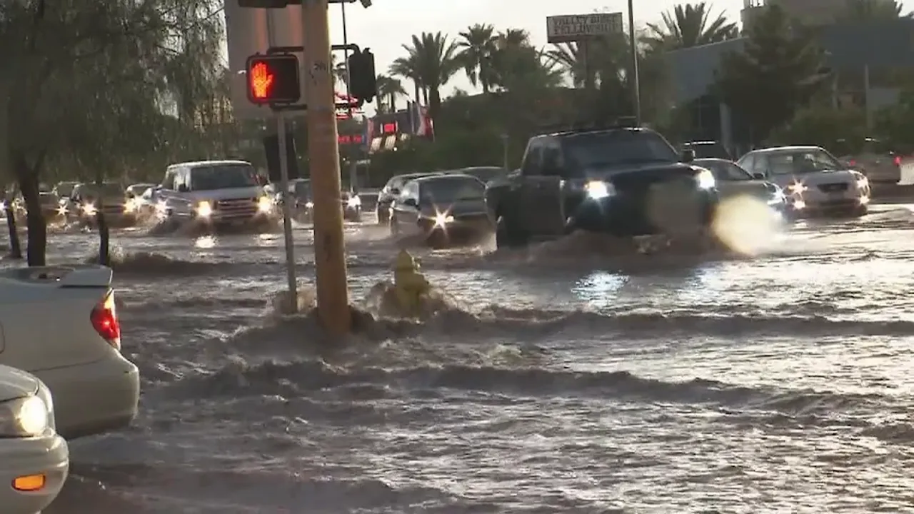 Cars driving through flooded streets in Las Vegas during heavy rain