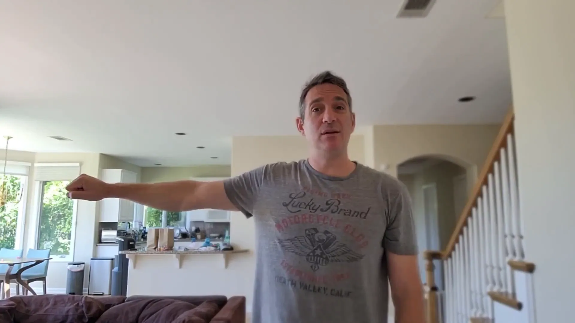 Scott performing lateral raises with a bottle of water