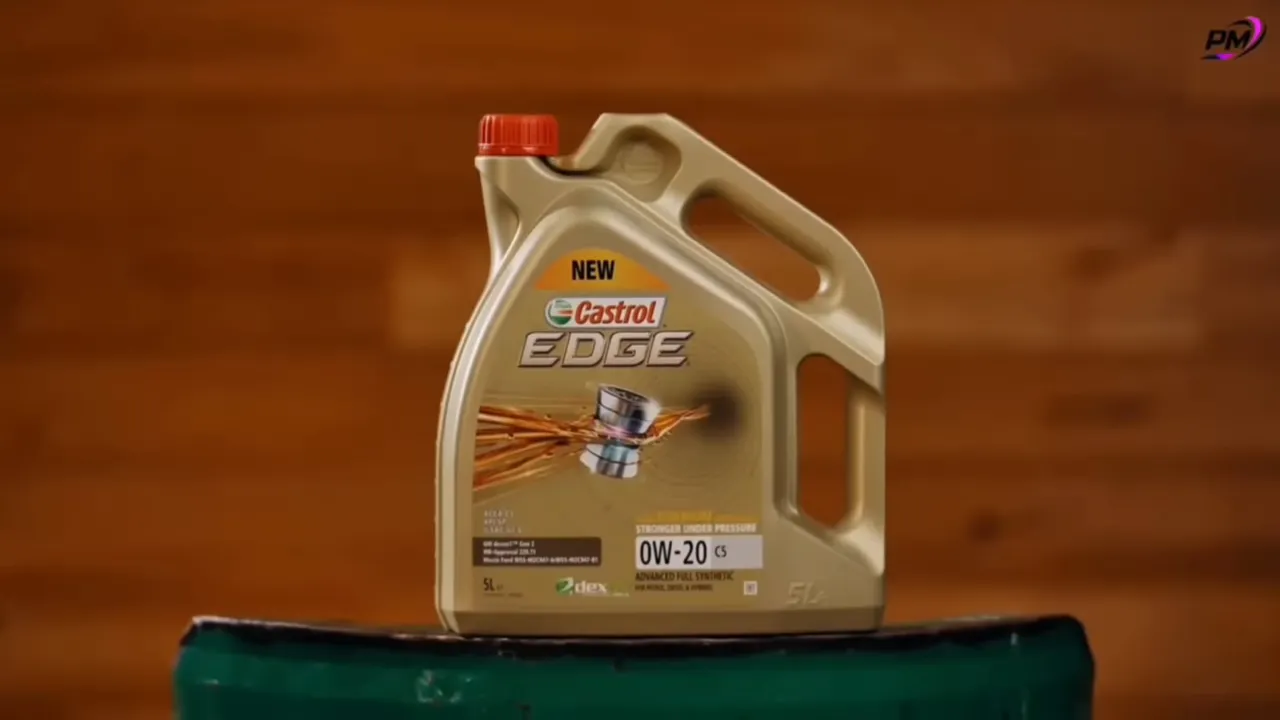 Castrol EDGE 0W-20 full synthetic motor oil jug on a wooden backdrop