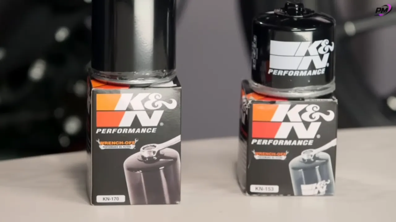 Two K&N black metal oil filter canisters sitting on K&N product boxes, showing sturdy metal construction