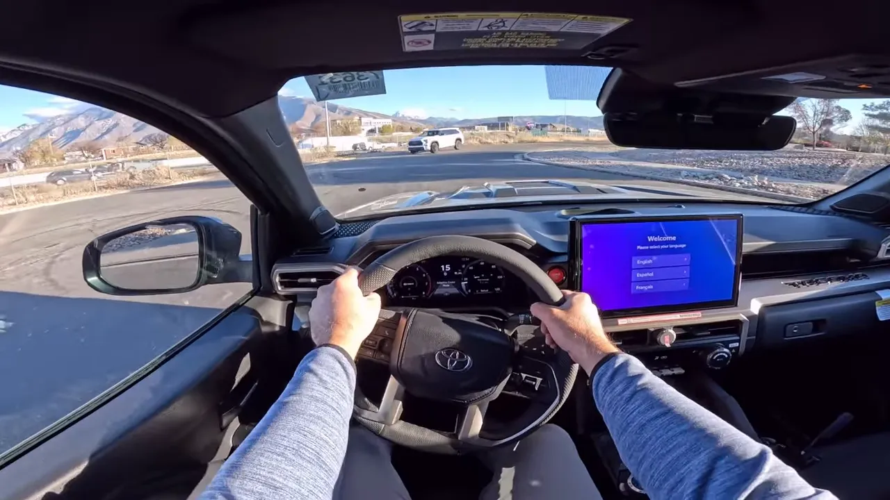 Tacoma driver POV both hands on steering wheel digital gauge cluster and clear view of road ahead