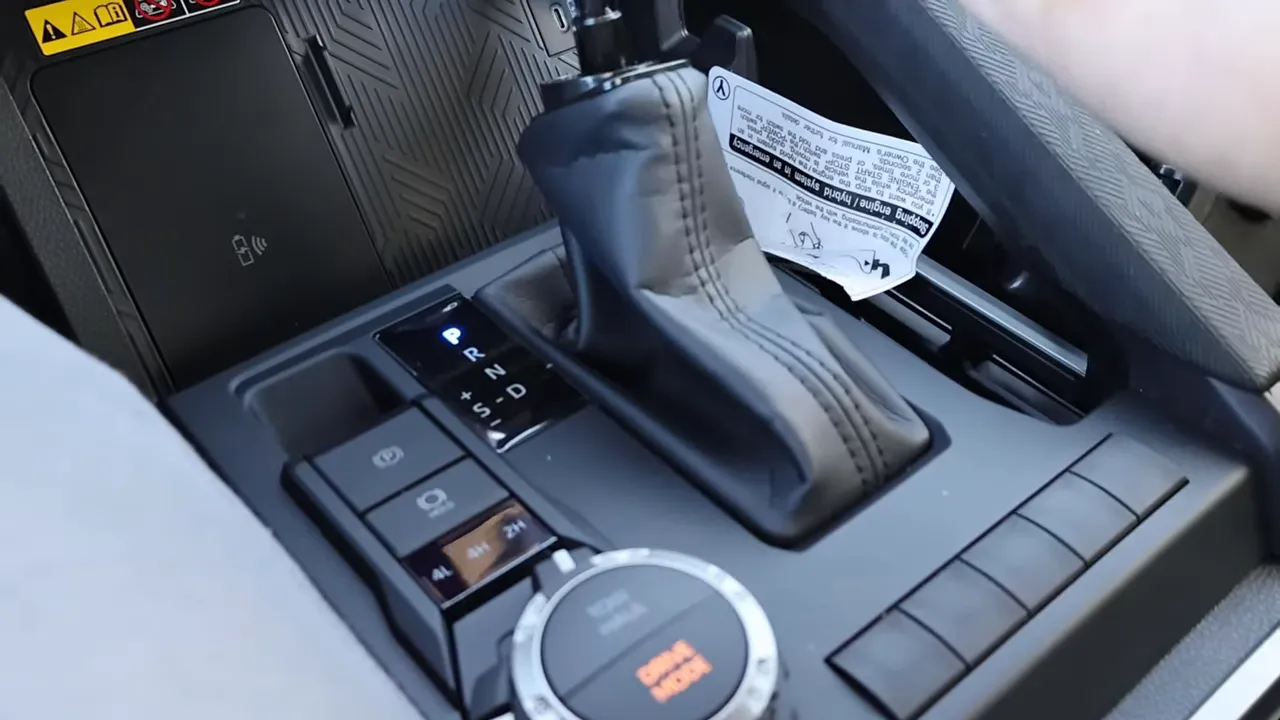 Toyota Tacoma center console showing shifter, drive-mode selector dial and surrounding function buttons