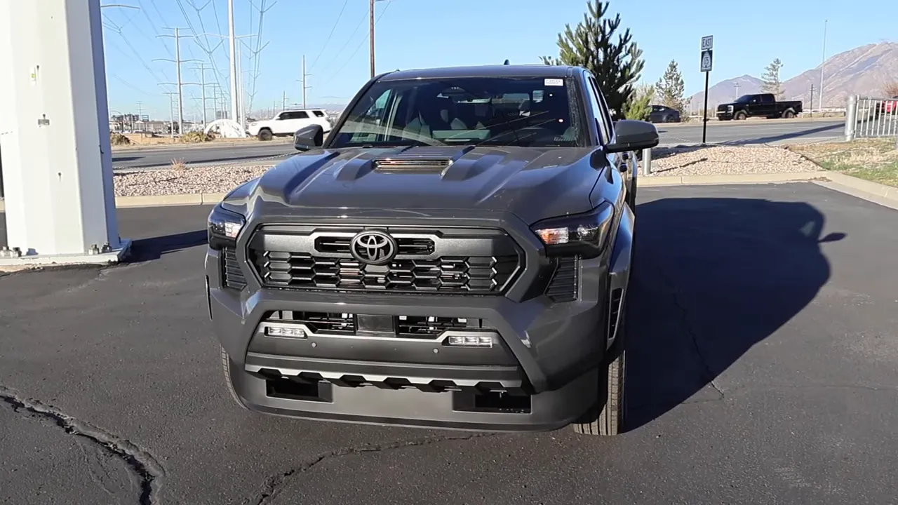 2026 Toyota Tacoma TRD Sport front view showing grille, faux hood vent and headlights