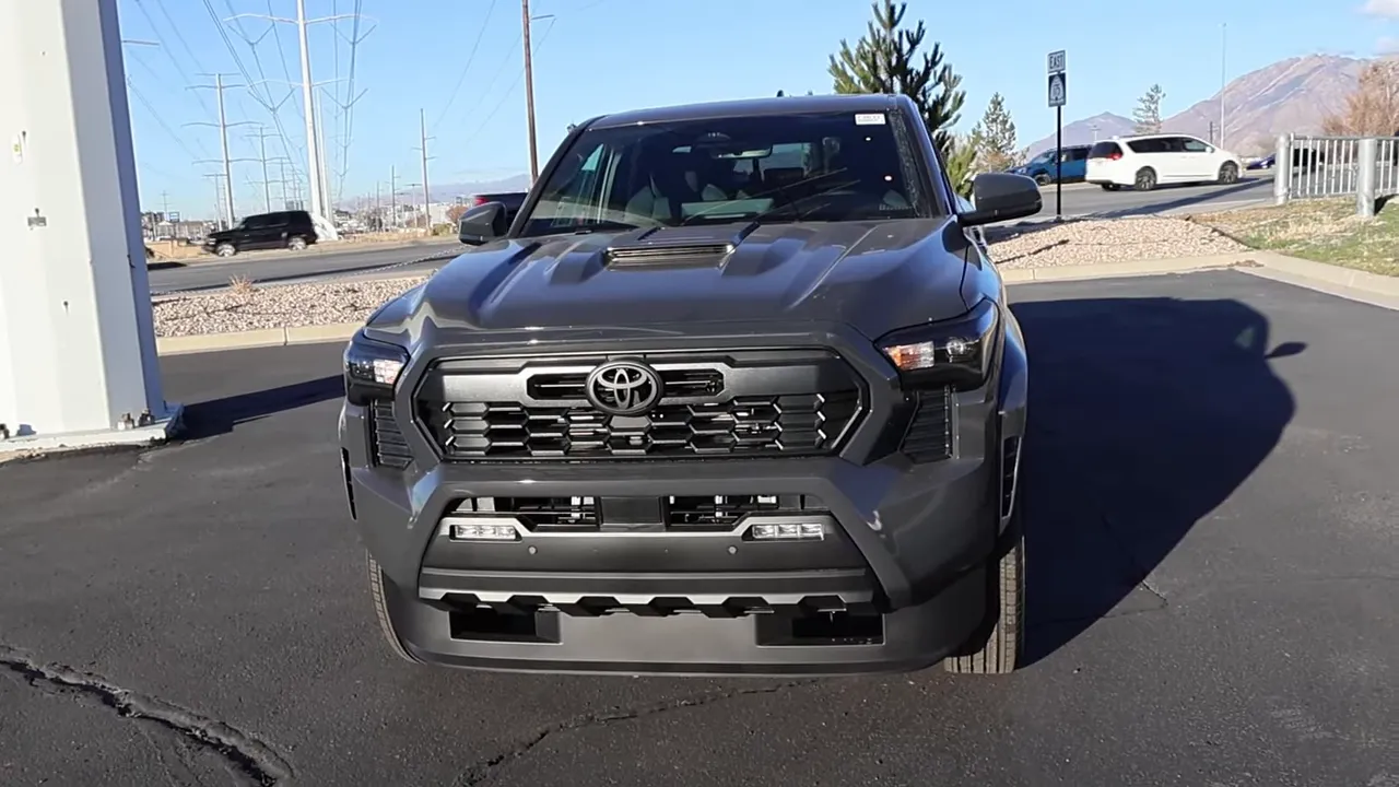 2026 Toyota Tacoma TRD Sport front view showing grille, faux hood vent and headlights