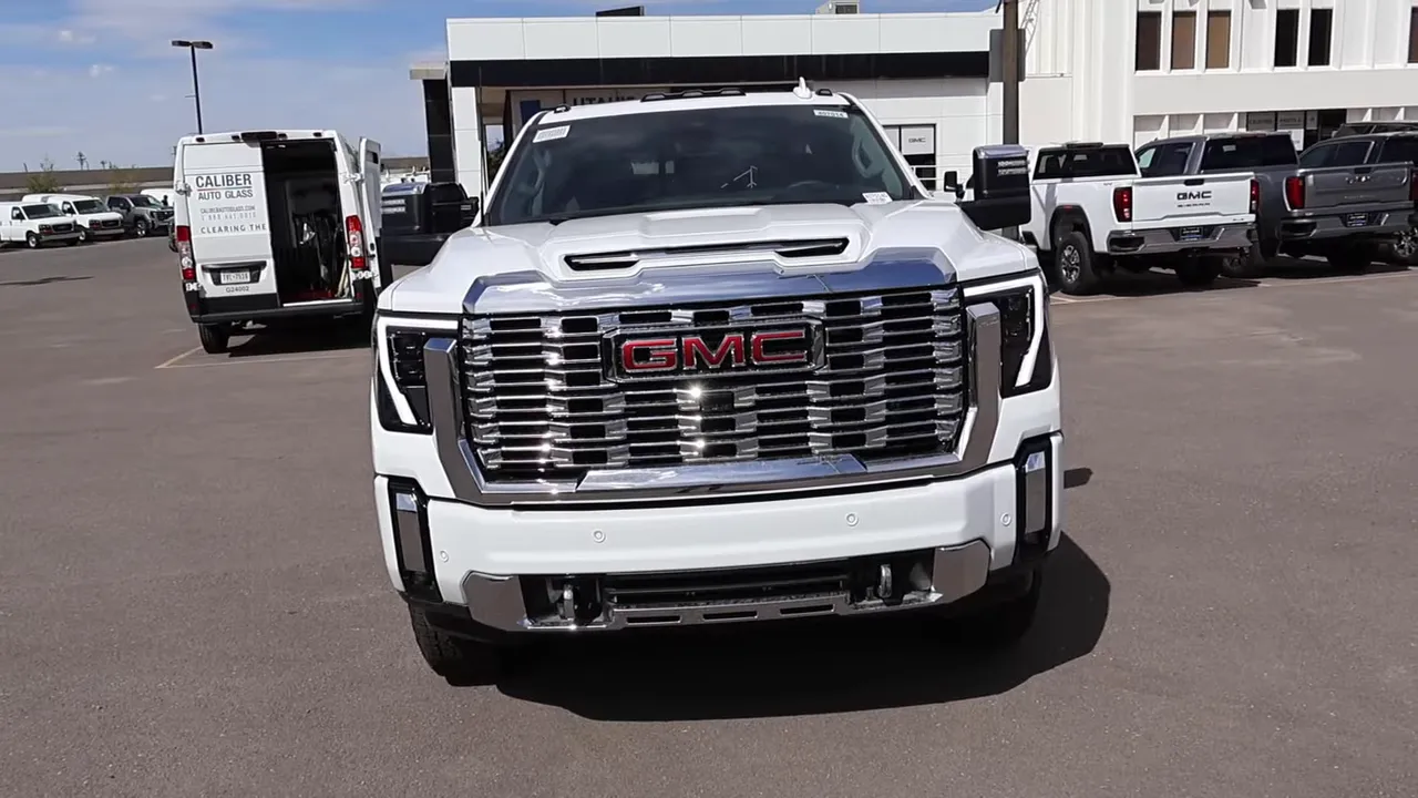 Full frontal view of 2026 GMC Sierra 3500 Denali showing signature chrome grille, GMC badge and hood scoop