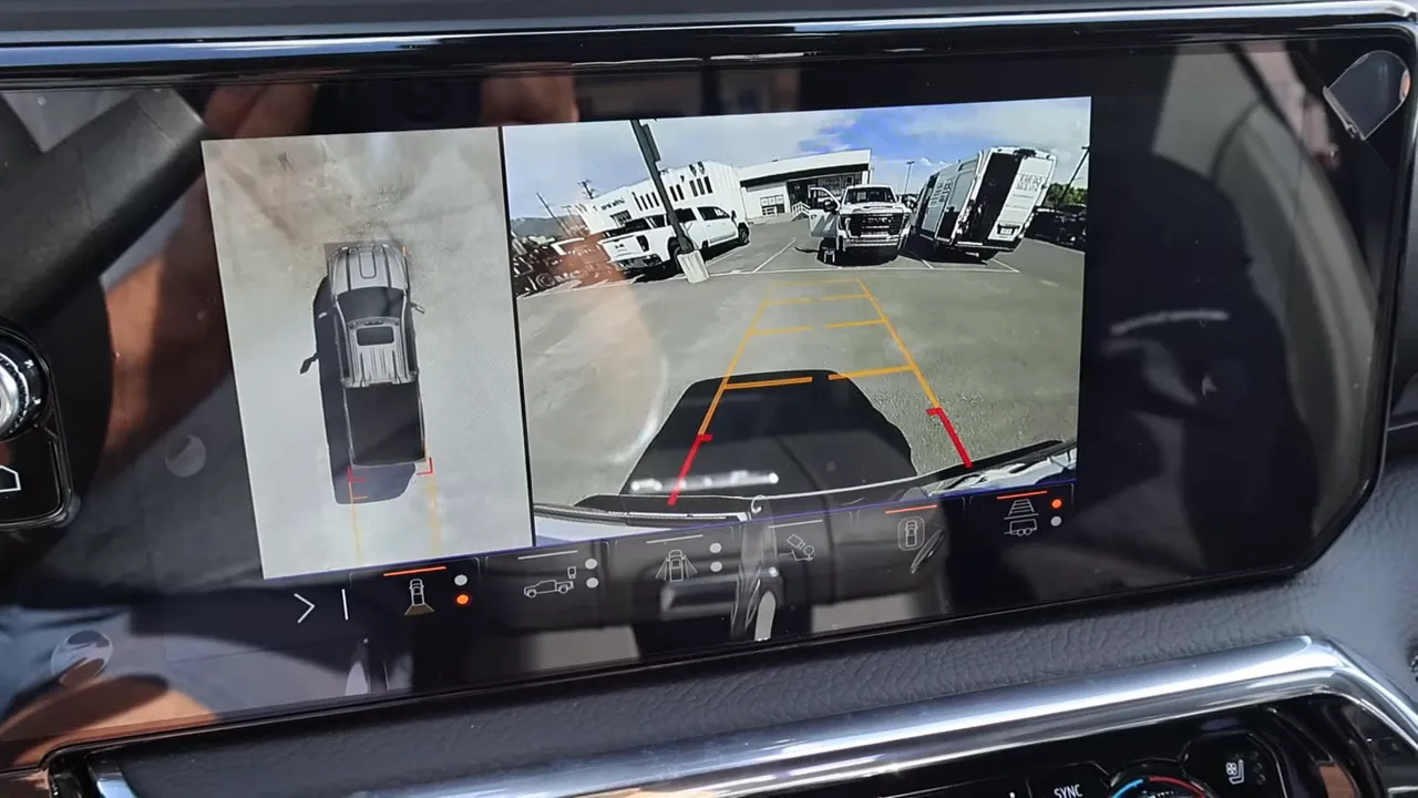 GMC Sierra 3500 Denali 360-degree camera split-screen showing top-down and rear views with parking guides