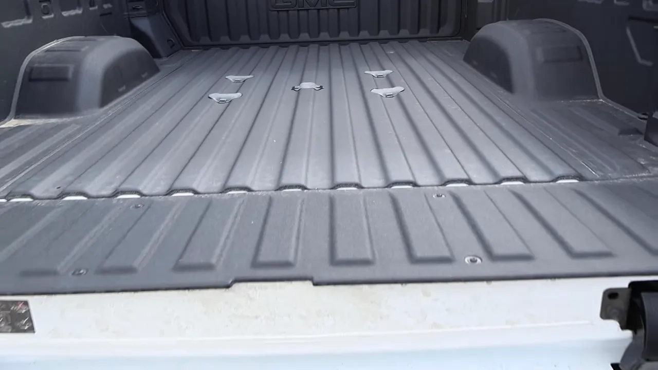 Full view of GMC Sierra 3500 bed with integrated anchors and spray-in liner
