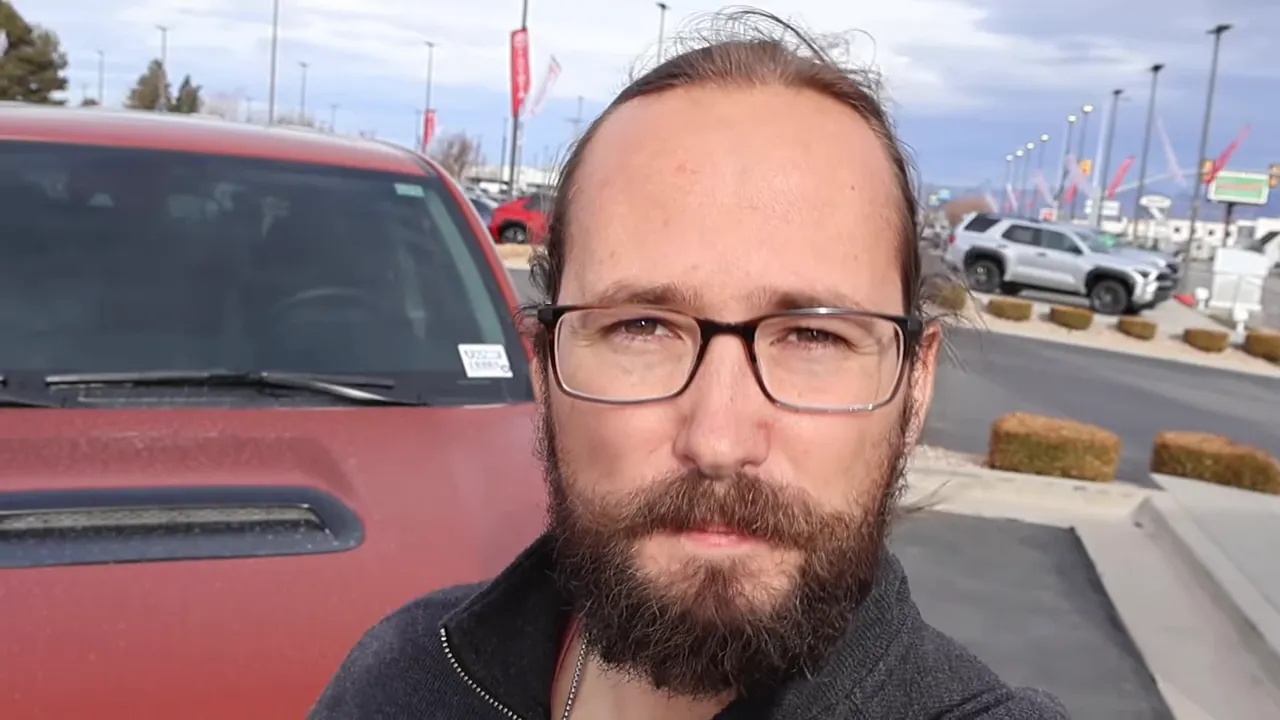 5th‑generation Toyota 4Runner parked at a dealership with the presenter in the foreground