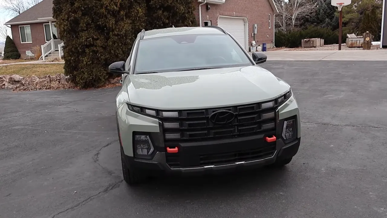 Head-on view of 2026 Hyundai Santa Cruz XRT showing grille, headlights, chunky fenders and red recovery hooks
