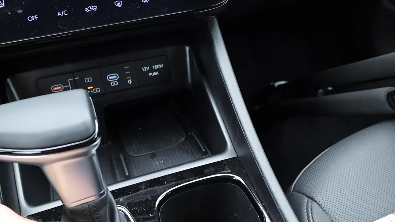 Hyundai Santa Cruz center console showing wireless phone charging pad, USB-C ports and 12V outlet