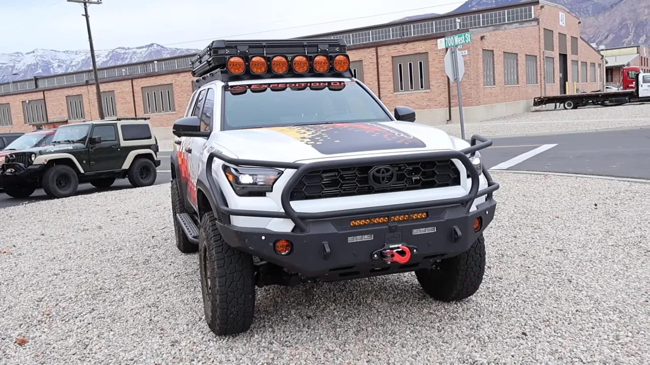 Front three-quarter view of Expedition One Toyota 4Runner with steel bumper, brush guard, roof rack and winch