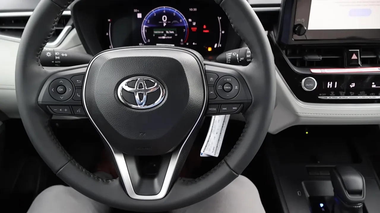 Toyota Corolla Cross steering wheel with control buttons and instrument cluster behind