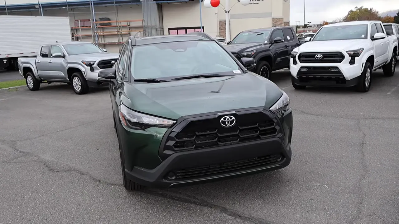 2026 Toyota Corolla Cross LE AWD front three-quarter view in deep green