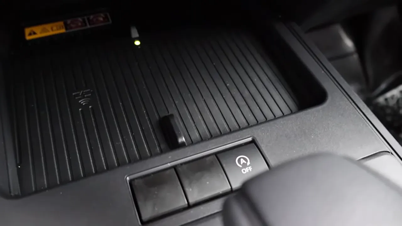 Recessed wireless phone charging pad with indicator light in the center console of a 2026 Toyota Corolla Cross