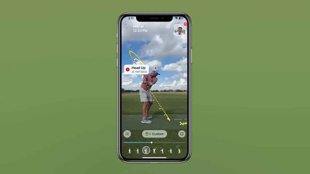 Smartphone showing the Swing Coach app with a tracked golf swing, dotted club path and a 'Head Up' metric.