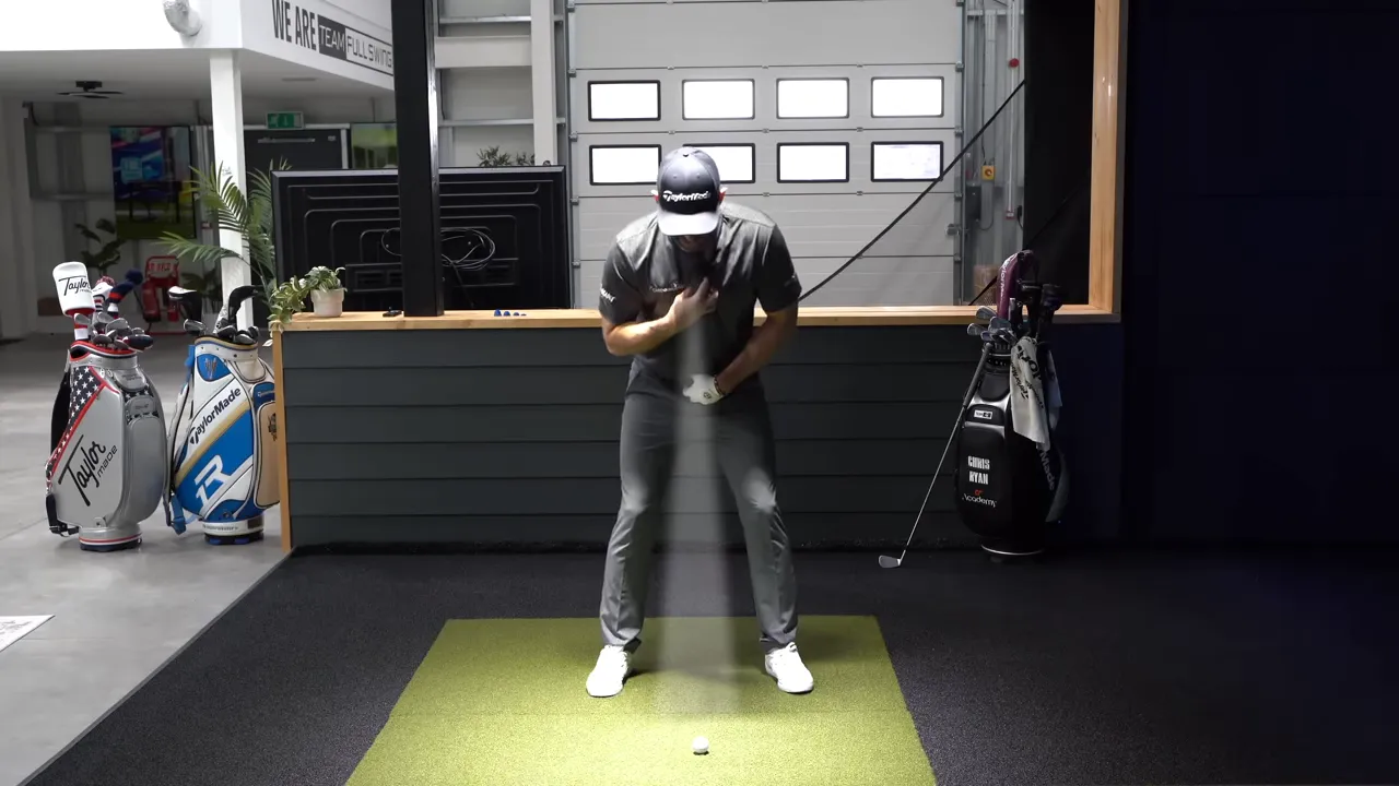 Golf instructor bent at the hips with a light-beam overlay from chest to the golf ball showing torch pointing down