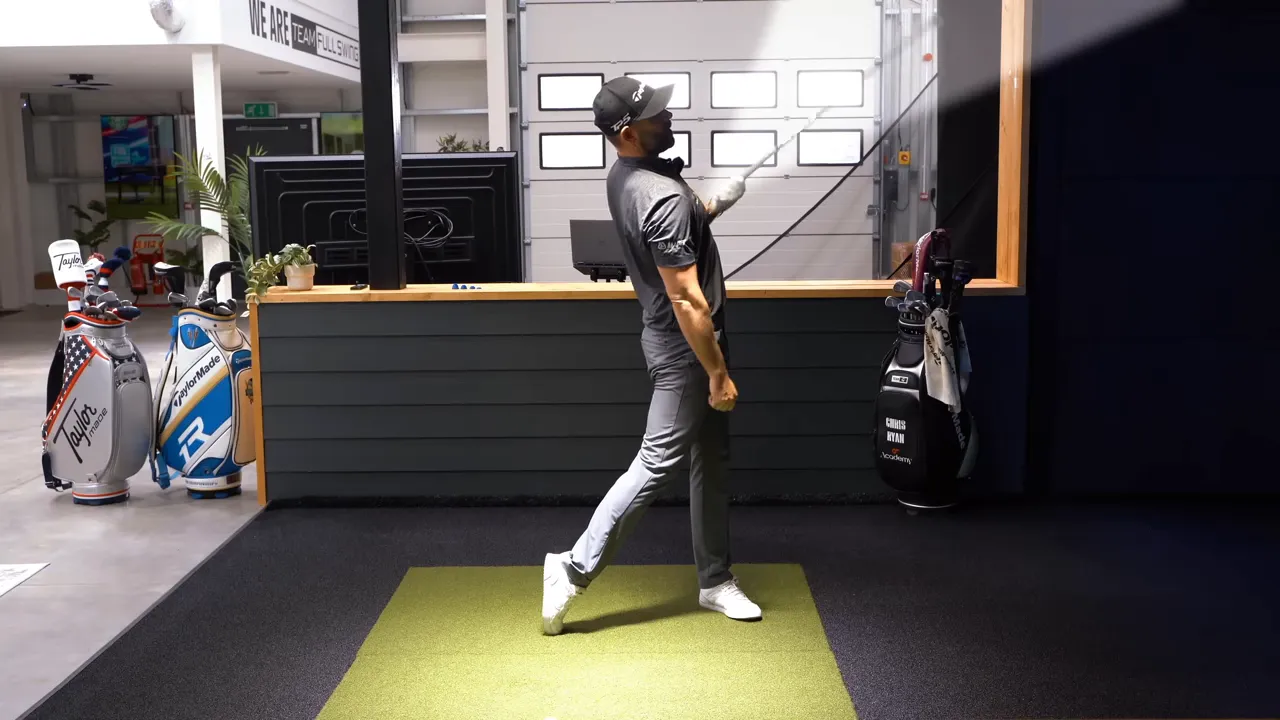 Golfer in full finish showing follow-through extension with chest elevated and club behind