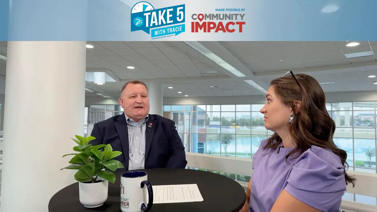 Warren Porter mid-sentence during an interview with Tracie Kamenoff, studio backdrop visible