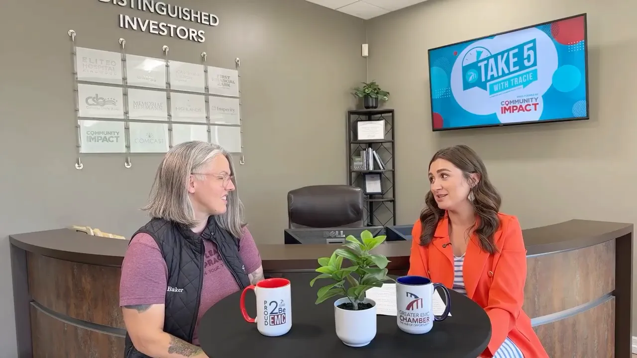 Dr. Lauren Baker explaining chiropractic care to Tracie Kamenoff in her office