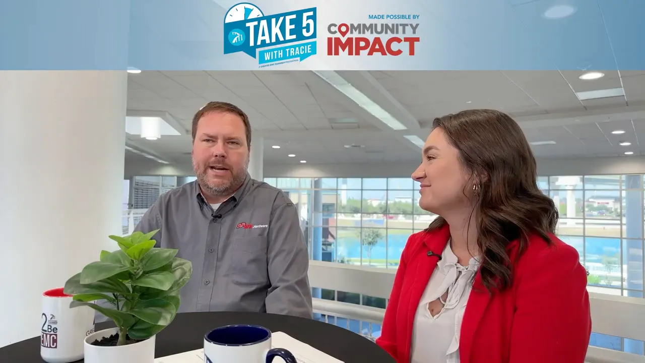 Jeff Peterson speaking to camera with host Tracie looking on during a Take 5 with Tracie interview, clear studio background and branded banner.
