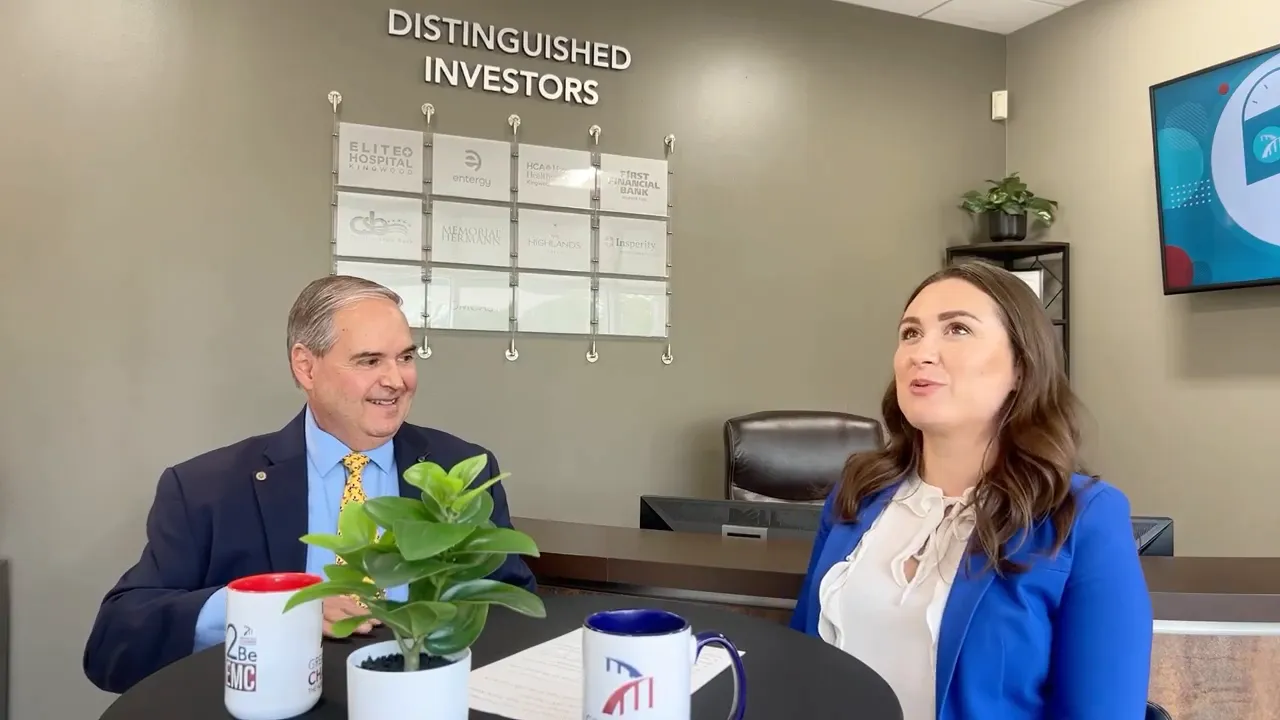 Oscar Martinez and Tracie Kamenoff at a meeting table in Frost Bank office