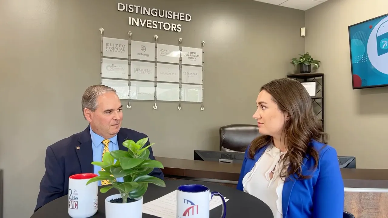 Oscar Martinez explaining Frost Bank’s community involvement to Tracie Kamenoff