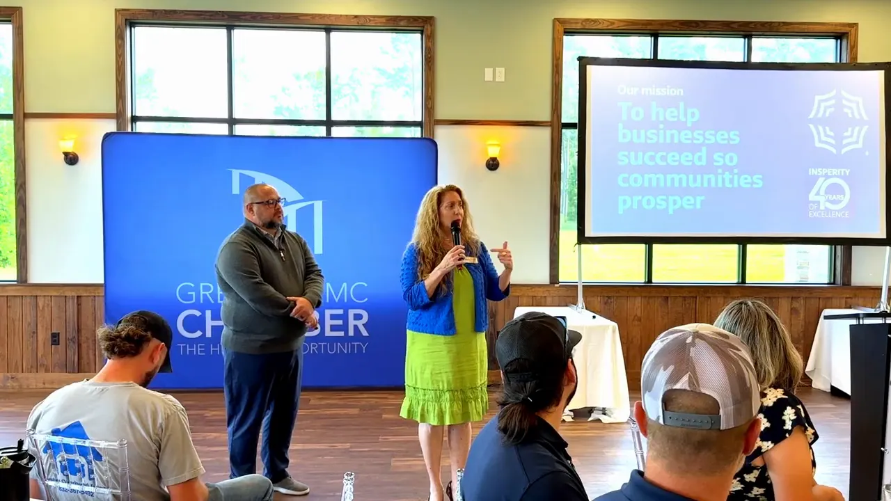 Insperity speakers presenting at a Business Networking Breakfast with HR-focused messaging on the screens