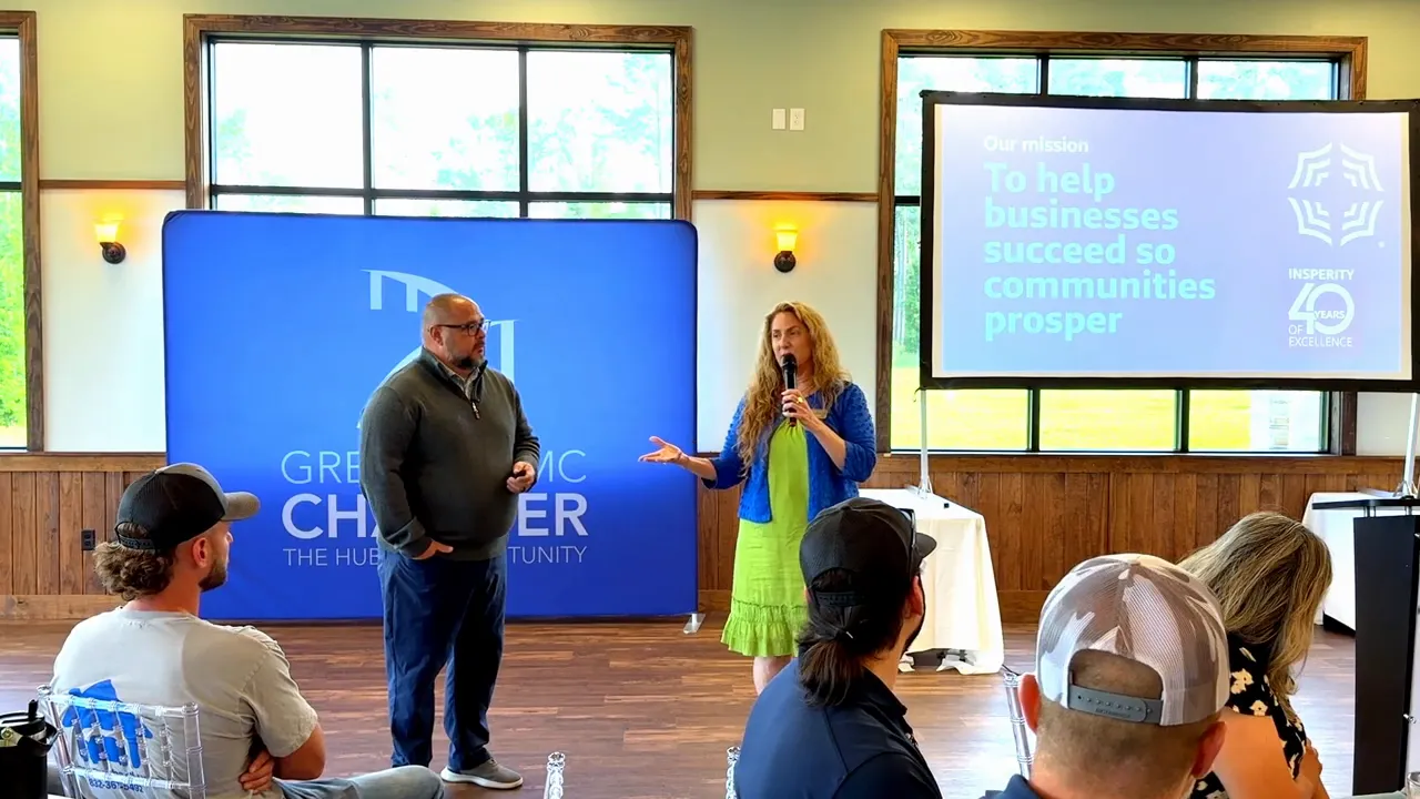 Insperity speaker making a point during the Business Networking Breakfast with HR and community messaging on screen