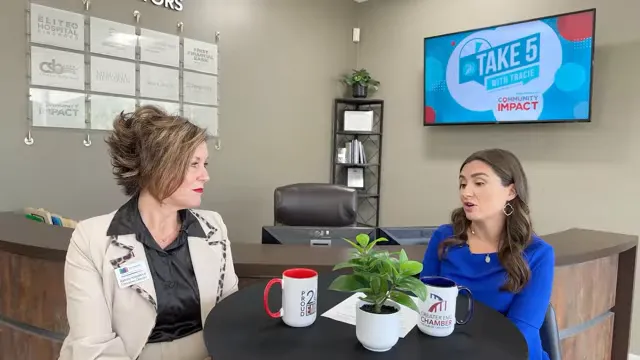 Tracie Kamenoff and Katrina Kirkpatrick talking across a table with coffee mugs and plants