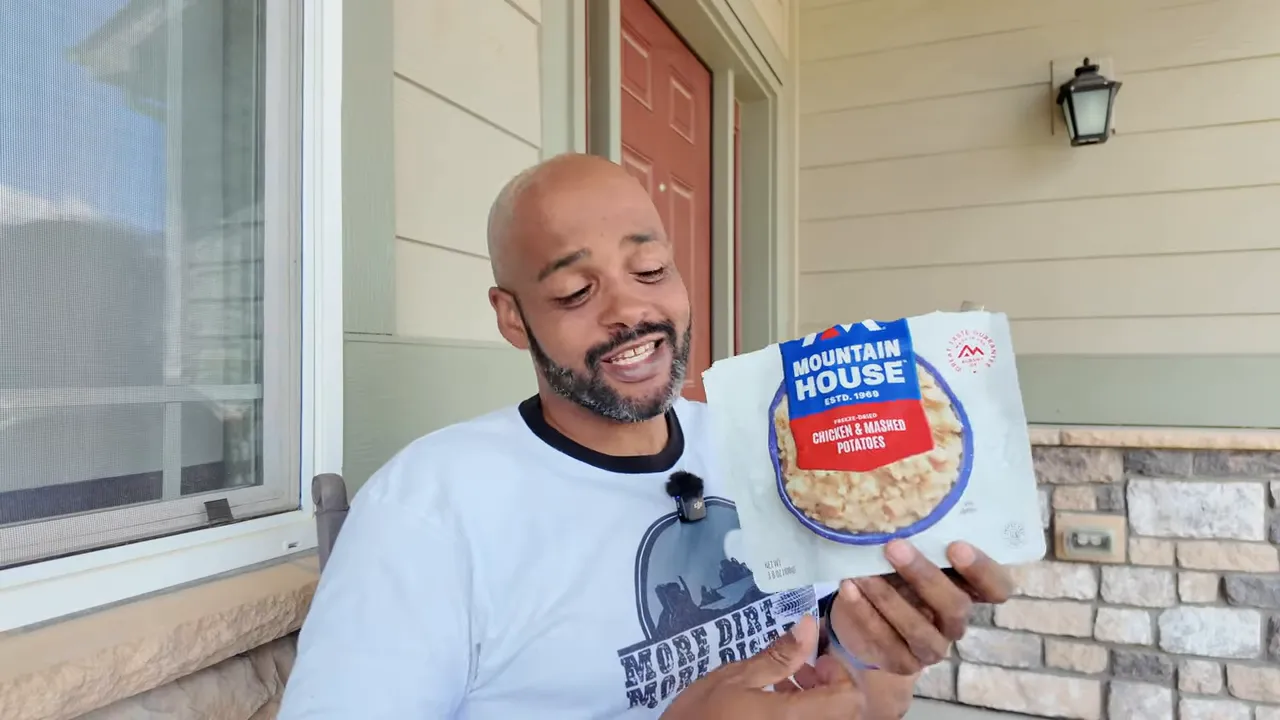 Chicken and mashed potatoes in bowl at campsite