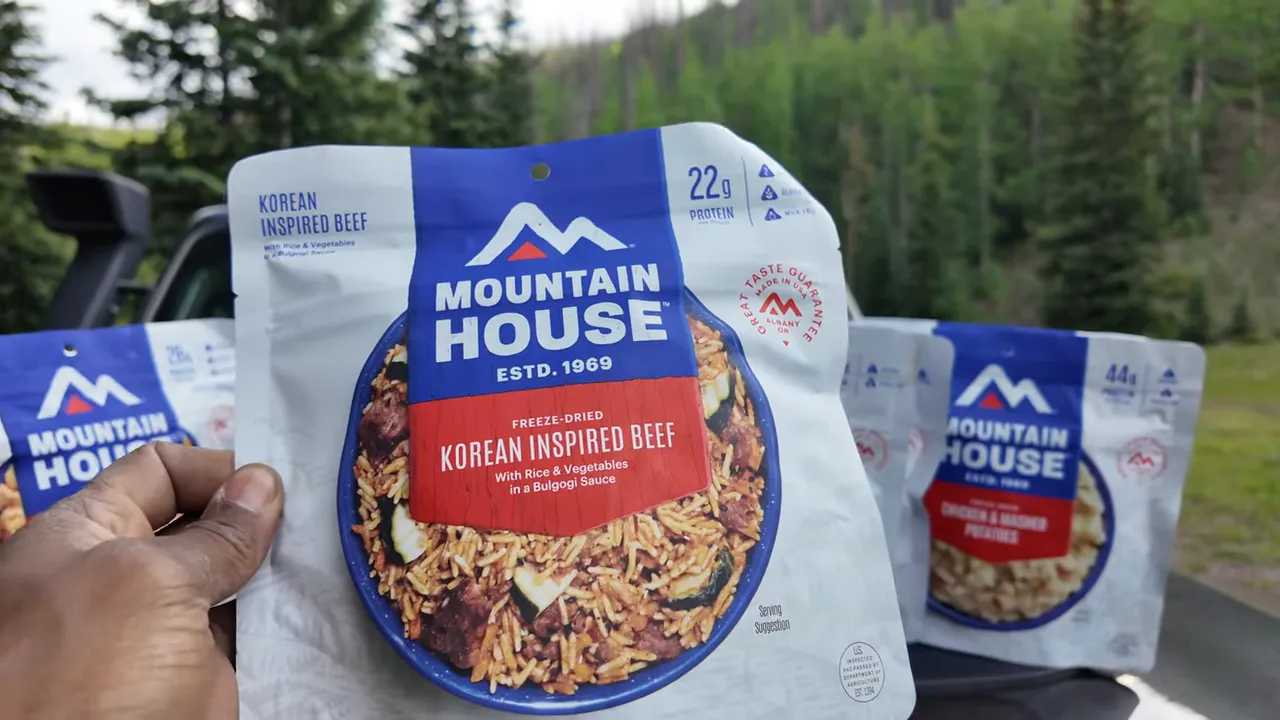 Stack of Mountain House meals laid out at campsite