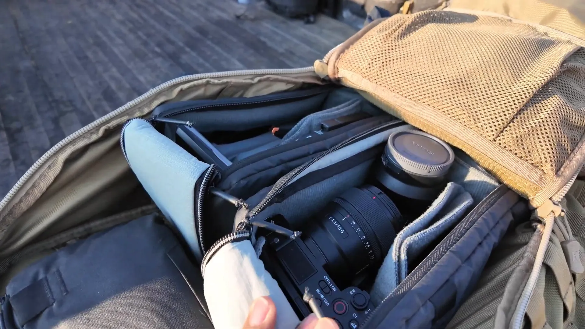 Main compartment open showing camera gear and compartments